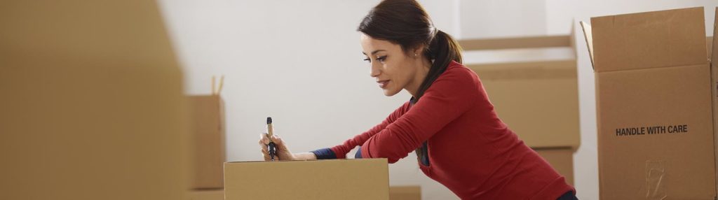 Caucasian woman moving to new apartment with boxes